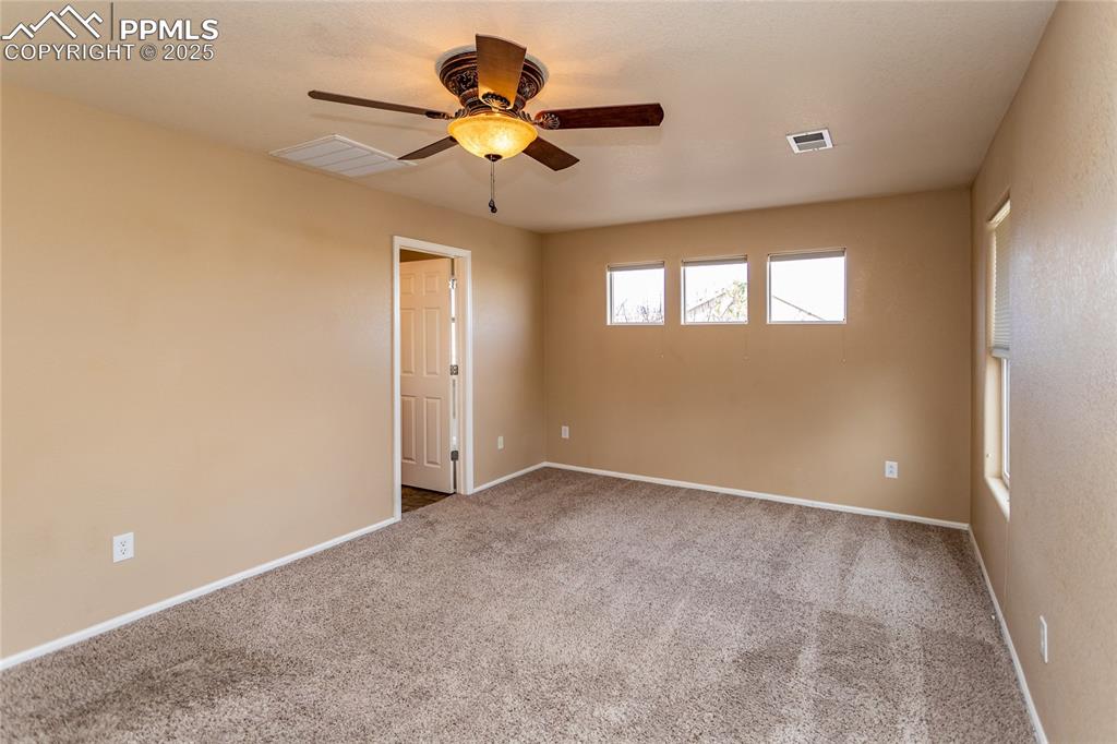 4829 Harrier Ridge Drive Colorado Springs, CO 80916 - Photo 26 of 50 an empty room with a window and a fan