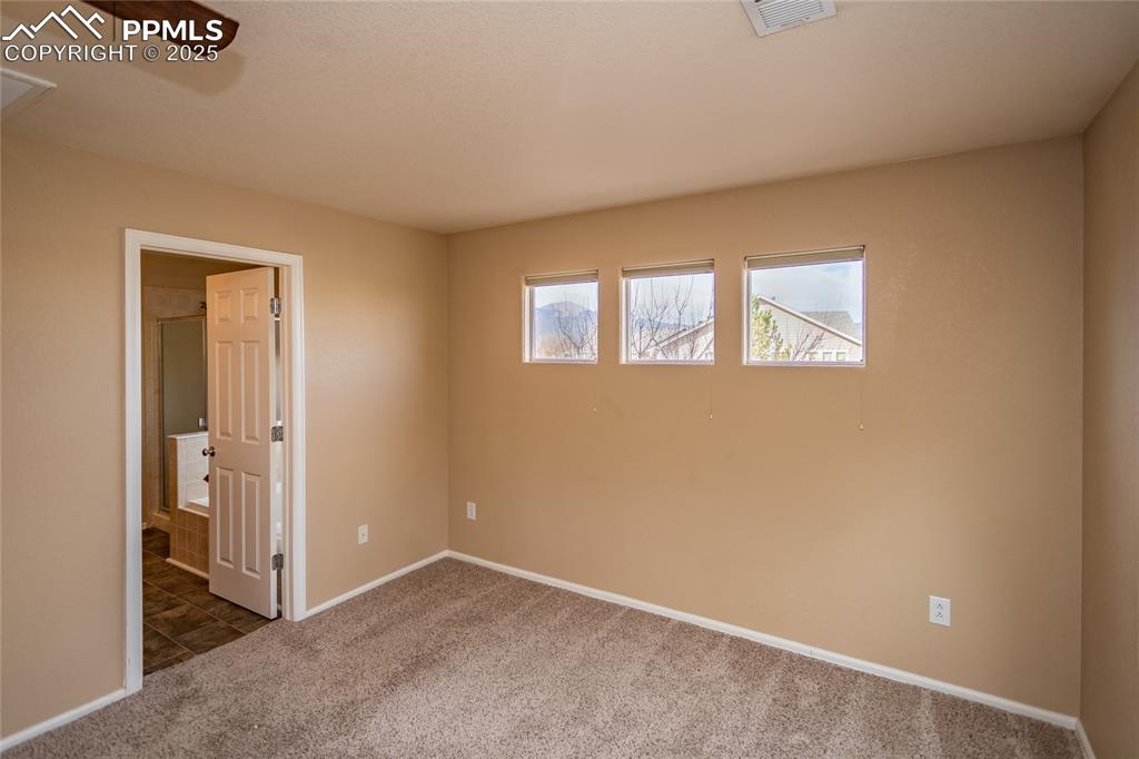 4829 Harrier Ridge Drive Colorado Springs, CO 80916 - Photo 27 of 50 an empty room with windows