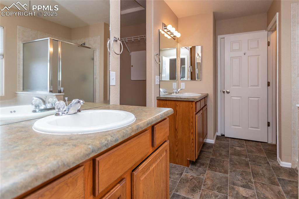 4829 Harrier Ridge Drive Colorado Springs, CO 80916 - Photo 29 of 50 a bathroom with a sink and a mirror