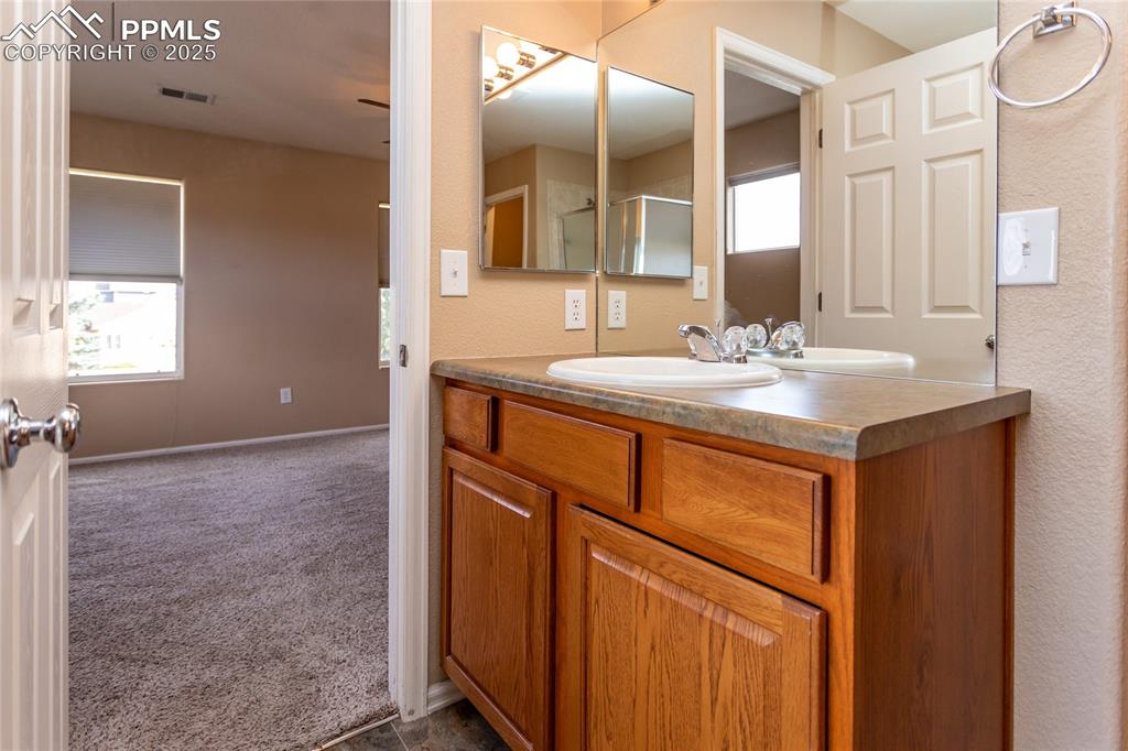 4829 Harrier Ridge Drive Colorado Springs, CO 80916 - Photo 31 of 50 a bathroom with a sink and a mirror
