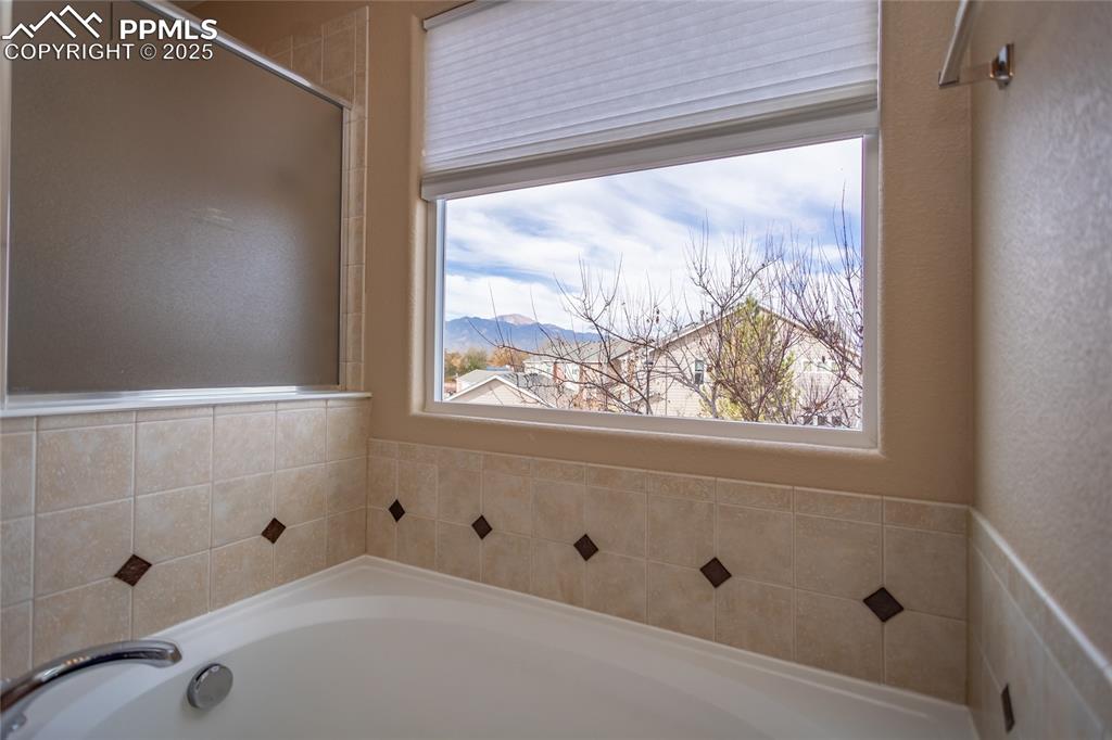 4829 Harrier Ridge Drive Colorado Springs, CO 80916 - Photo 32 of 50 a bathroom with a tub and shower