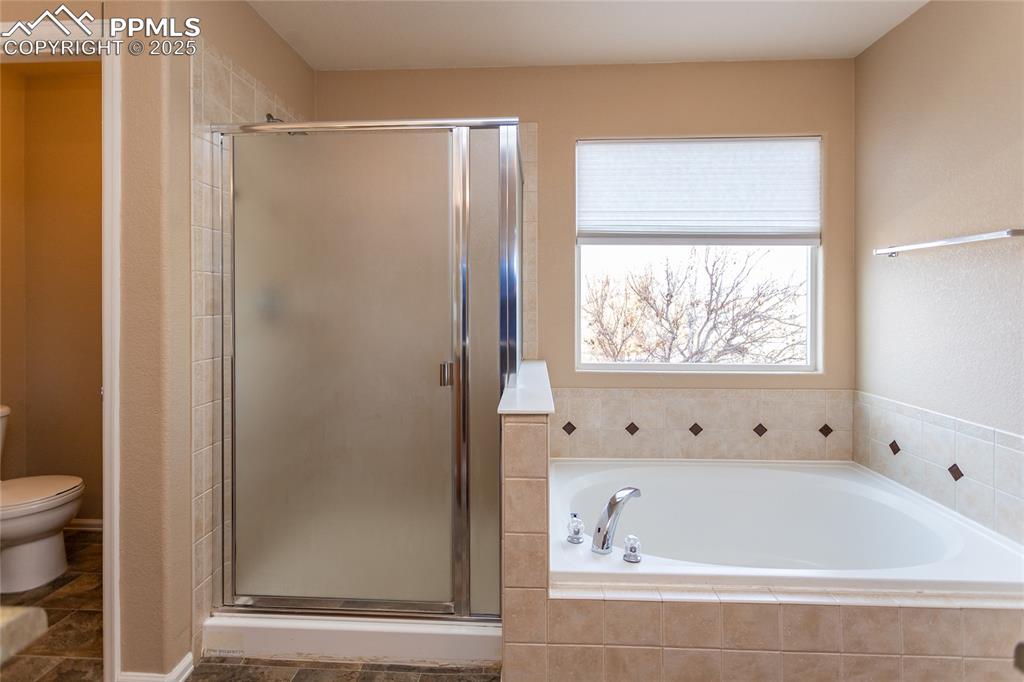 4829 Harrier Ridge Drive Colorado Springs, CO 80916 - Photo 34 of 50 a bathroom with a bathtub and a shower