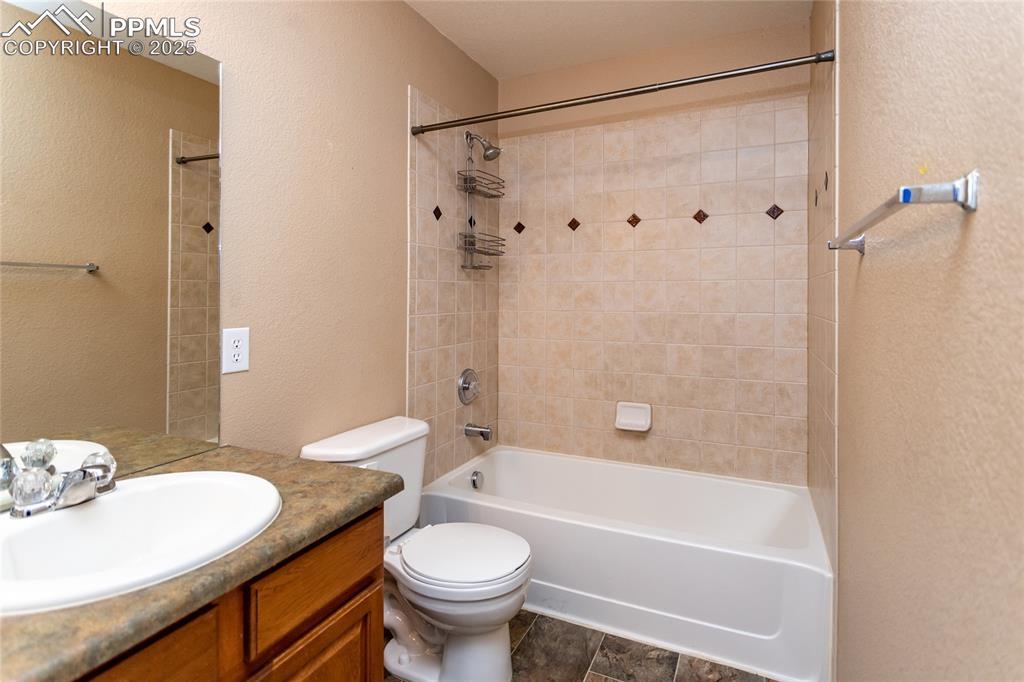 4829 Harrier Ridge Drive Colorado Springs, CO 80916 - Photo 40 of 50 a bathroom with a granite countertop sink toilet and shower