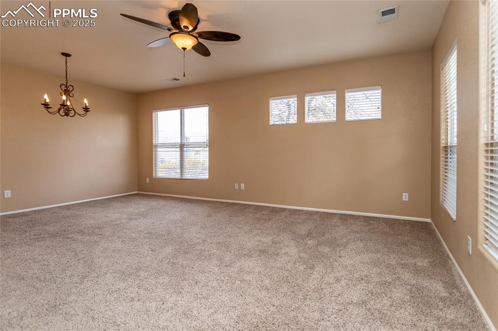4829 Harrier Ridge Drive Colorado Springs, CO 80916 - Photo 4 of 50 an empty room that has a window and a ceiling fan