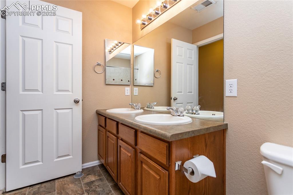 4829 Harrier Ridge Drive Colorado Springs, CO 80916 - Photo 41 of 50 a bathroom with a sink and a mirror