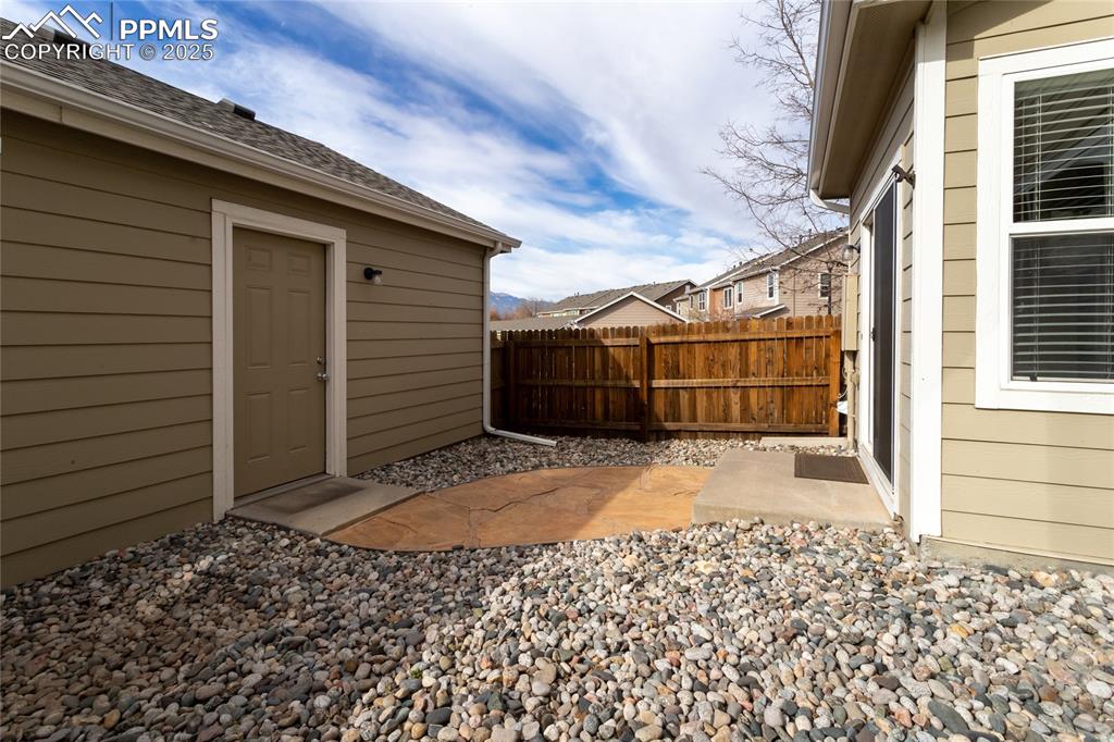 4829 Harrier Ridge Drive Colorado Springs, CO 80916 - Photo 45 of 50 a backyard of a house with a large tree
