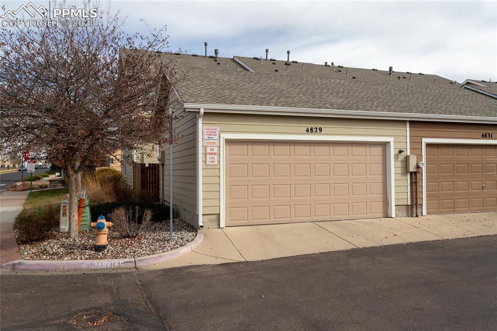 4829 Harrier Ridge Drive Colorado Springs, CO 80916 - Photo 49 of 50 a front view of a house with a yard