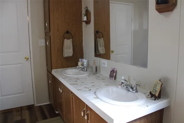 a bedroom with bed and a chandelier