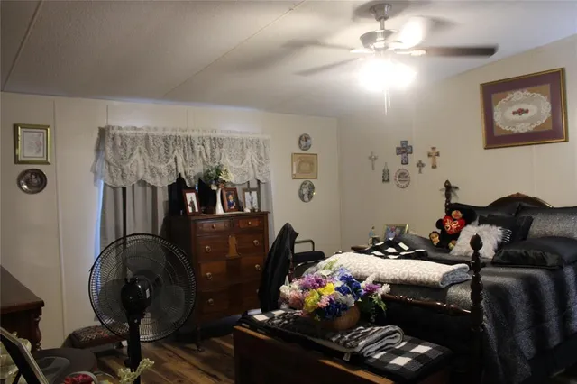 a living room with furniture flowers and a chandelier