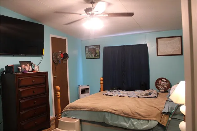 a bedroom with a bed and chair