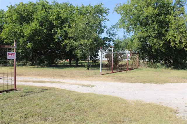 a view of backyard of house with green space