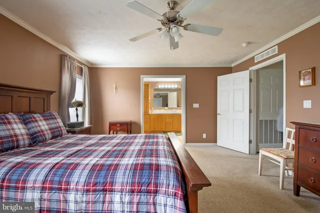 a spacious bathroom with a double vanity sink a mirror and a shower