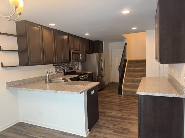 a kitchen with wooden cabinets a sink and a stove