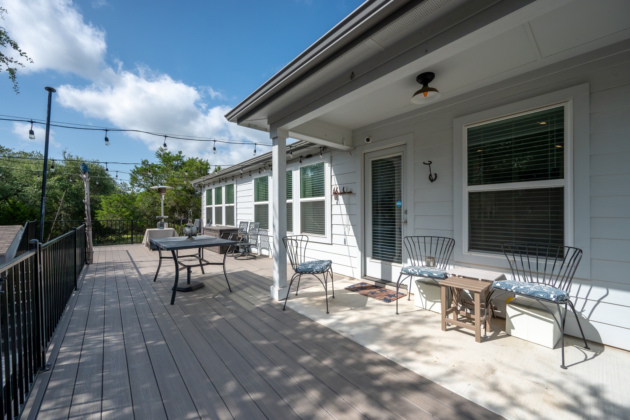 21006 Santa Rosa Avenue Lago Vista, TX 78645 - Photo 18 of 26 An inviting deck extends from the home, offering an excellent outdoor entertaining space amidst lush greenery.