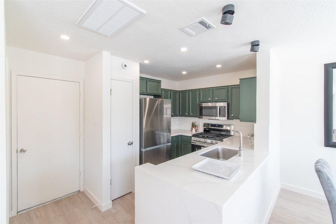 12447 South Rachlin Circle Houston, TX 77071 - Photo 13 of 34 a kitchen with stainless steel appliances a refrigerator and a stove