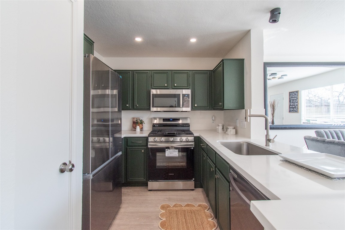 12447 South Rachlin Circle Houston, TX 77071 - Photo 14 of 34 a kitchen with stainless steel appliances granite countertop a sink stove and refrigerator