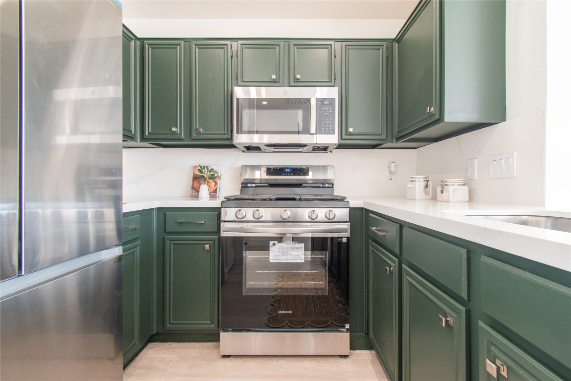 12447 South Rachlin Circle Houston, TX 77071 - Photo 15 of 34 a kitchen with stainless steel appliances granite countertop a stove and a microwave