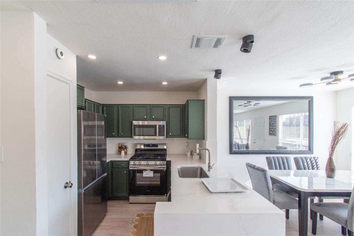 12447 South Rachlin Circle Houston, TX 77071 - Photo 17 of 34 a kitchen with microwave a stove and refrigerator