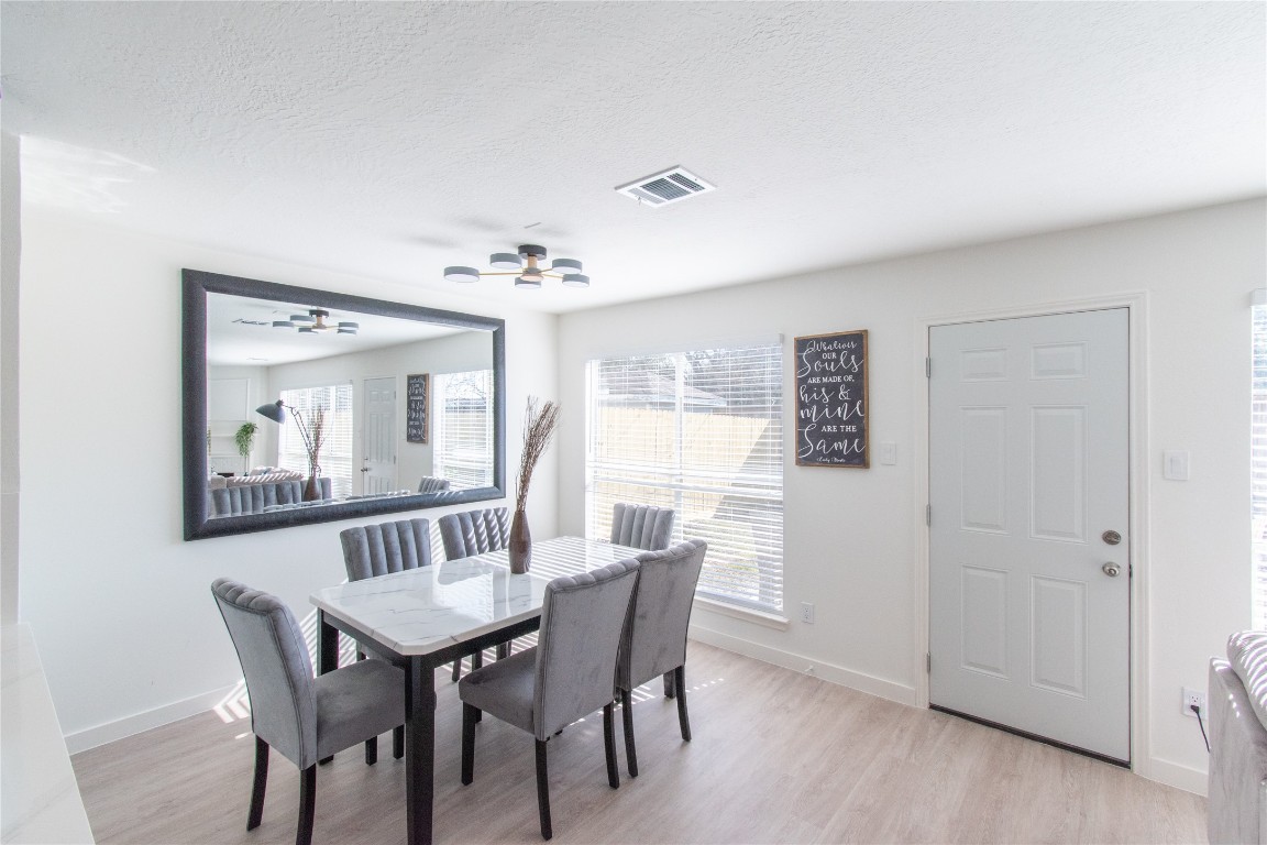 12447 South Rachlin Circle Houston, TX 77071 - Photo 19 of 34 a view of a dining room with furniture and wooden floor
