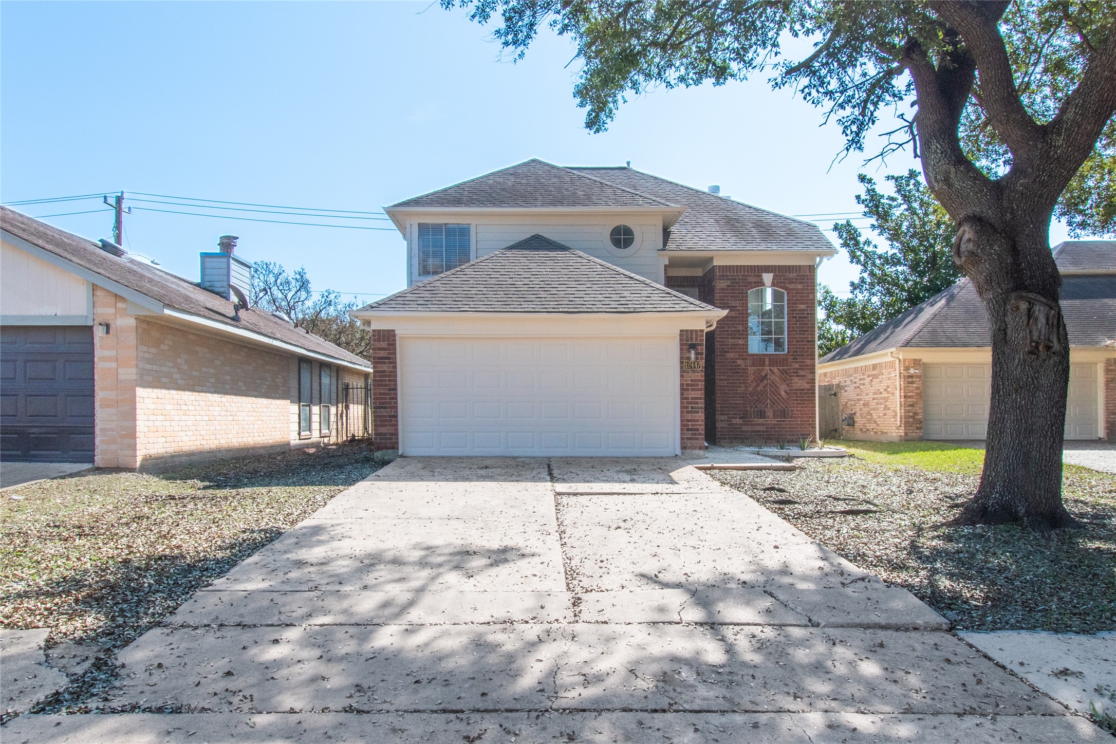 12447 South Rachlin Circle Houston, TX 77071 - Photo 4 of 34 a front view of a house with a yard and garage