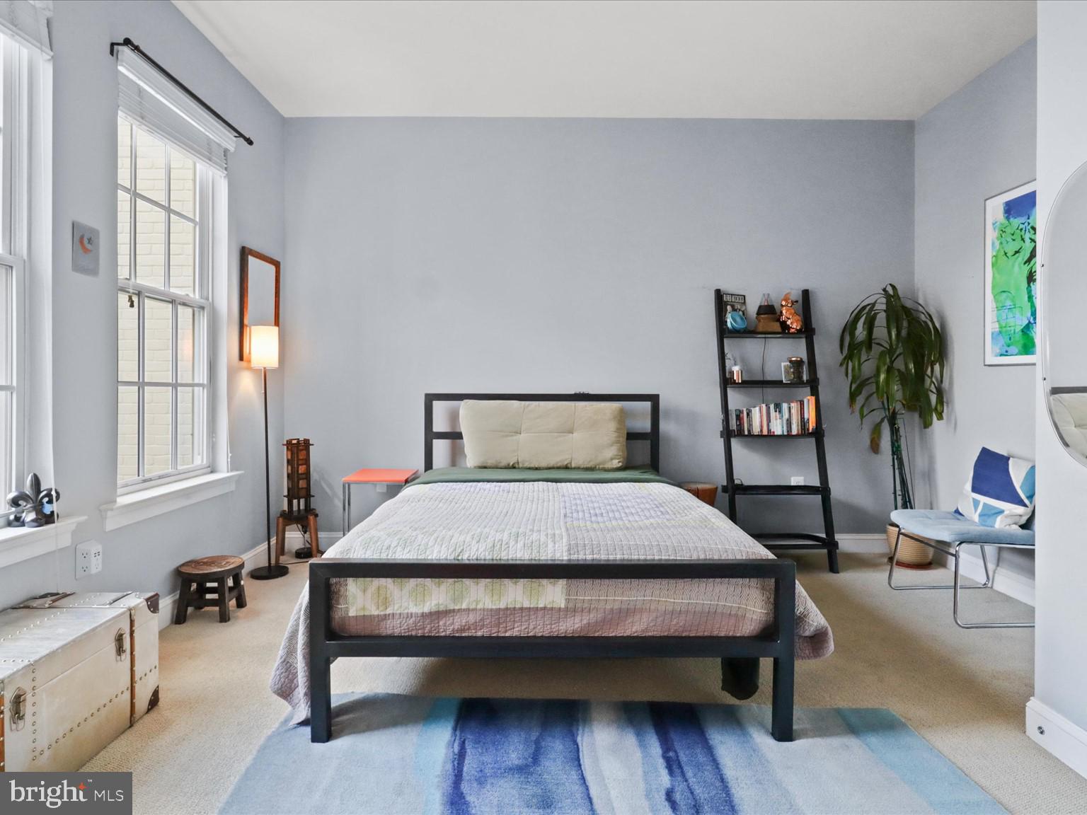 1023 North Royal Street, Unit 214 Alexandria, VA 22314 - Photo 11 of 38 a bedroom with a bed table chair and a window