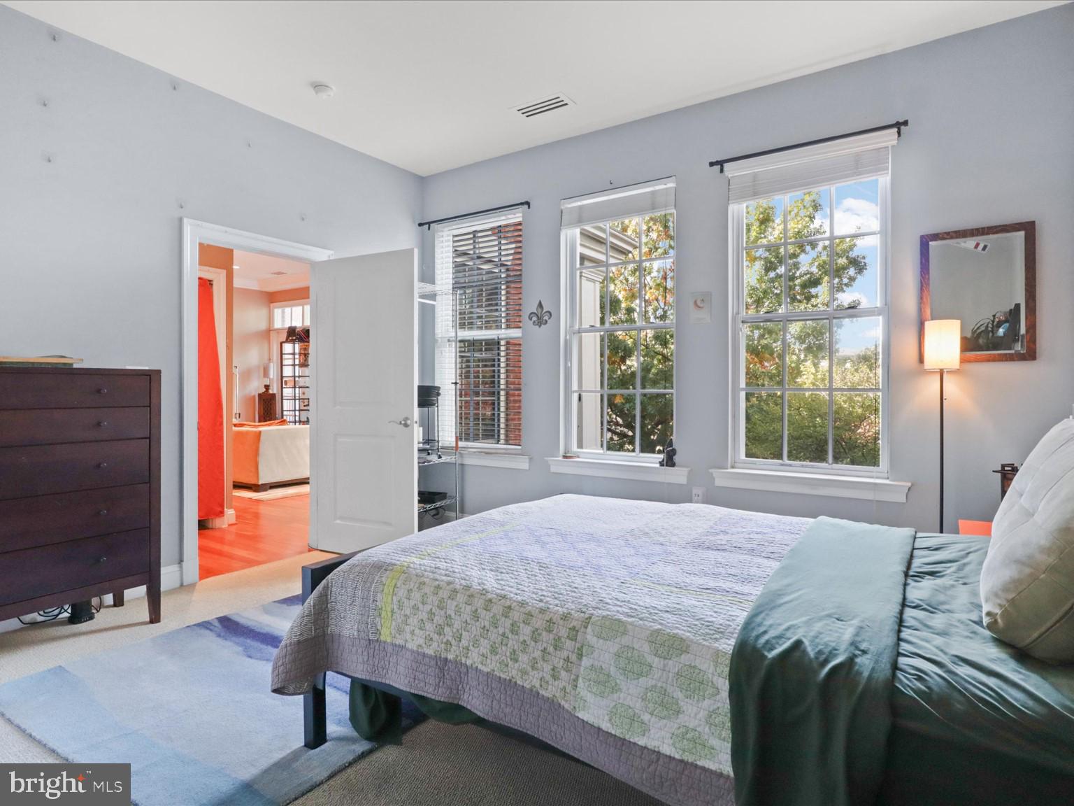 1023 North Royal Street, Unit 214 Alexandria, VA 22314 - Photo 12 of 38 a bedroom with a bed and wooden floor