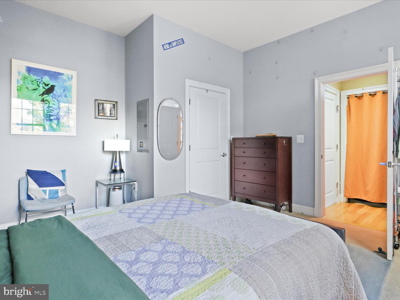 1023 North Royal Street, Unit 214 Alexandria, VA 22314 - Photo 13 of 38 a bedroom with a bed and wooden floor