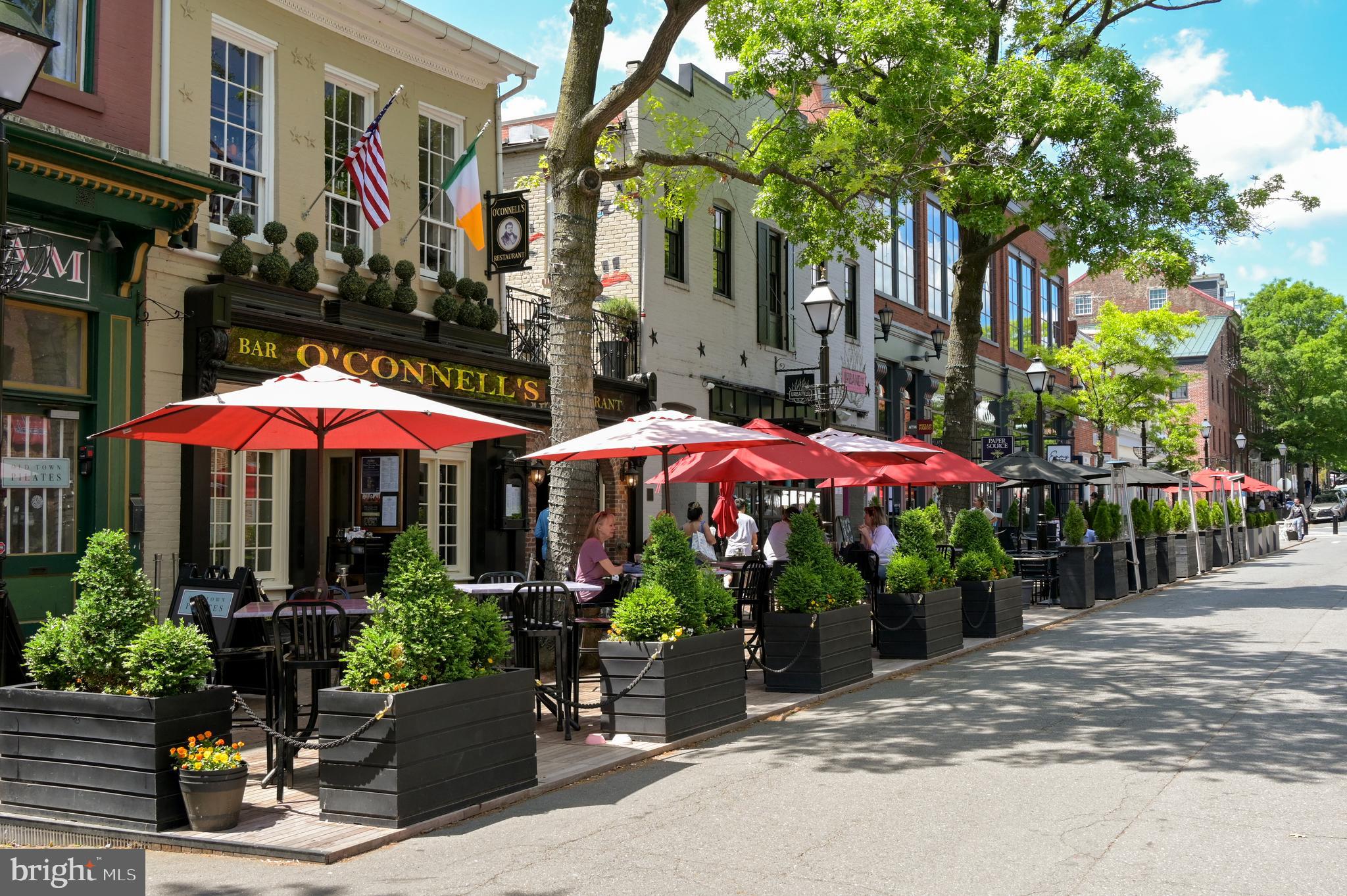 1023 North Royal Street, Unit 214 Alexandria, VA 22314 - Photo 29 of 38 a view of a patio with plants and a table and chairs under an umbrella