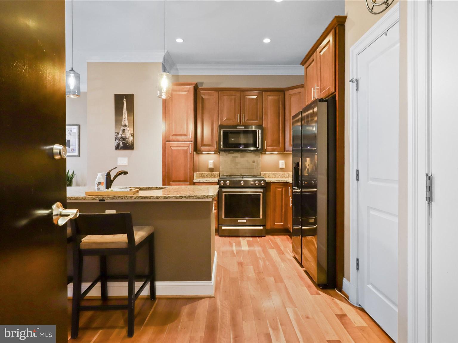 1023 North Royal Street, Unit 214 Alexandria, VA 22314 - Photo 3 of 38 a kitchen with a sink appliances and cabinets