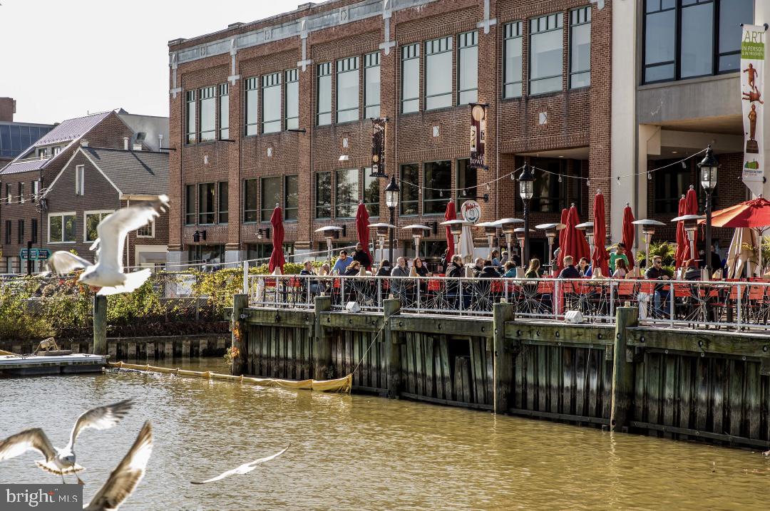 1023 North Royal Street, Unit 214 Alexandria, VA 22314 - Photo 34 of 38 a view of a lake with a chairs and a table in the patio