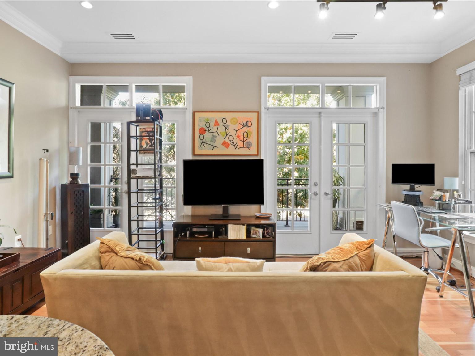 1023 North Royal Street, Unit 214 Alexandria, VA 22314 - Photo 8 of 38 a living room with furniture and a flat screen tv