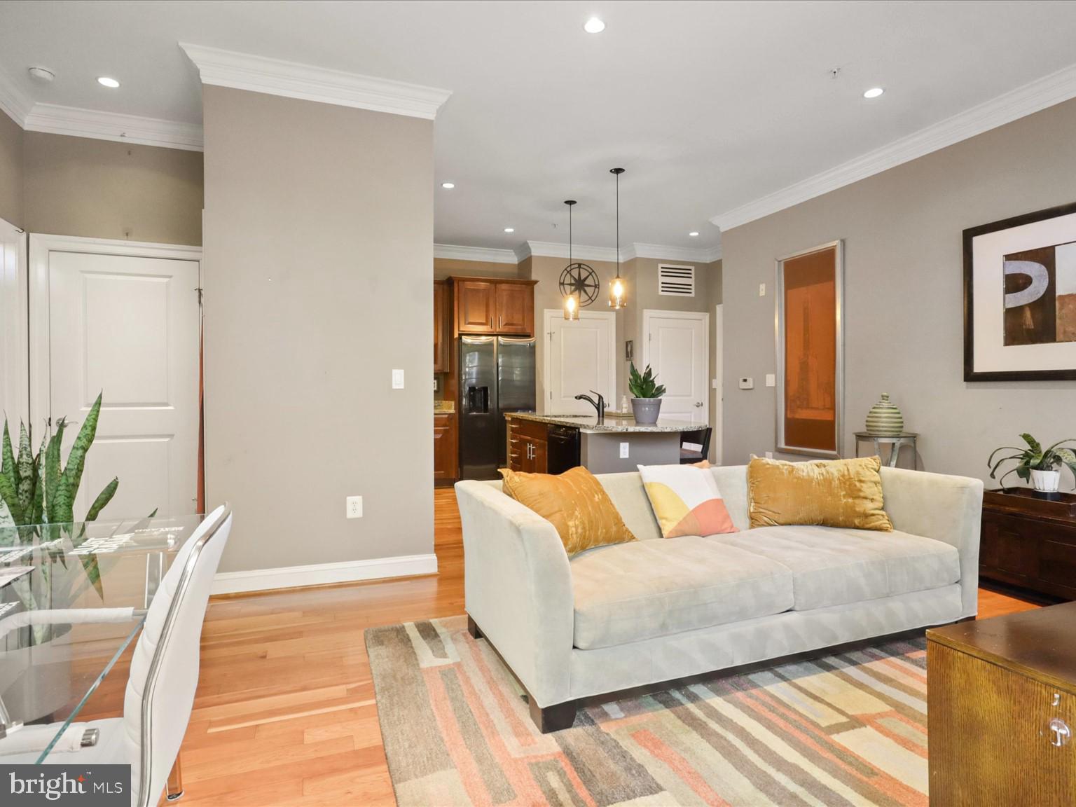 1023 North Royal Street, Unit 214 Alexandria, VA 22314 - Photo 10 of 38 a living room with furniture and a large window
