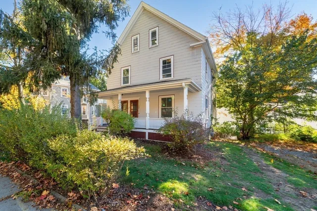 a front view of house with a garden