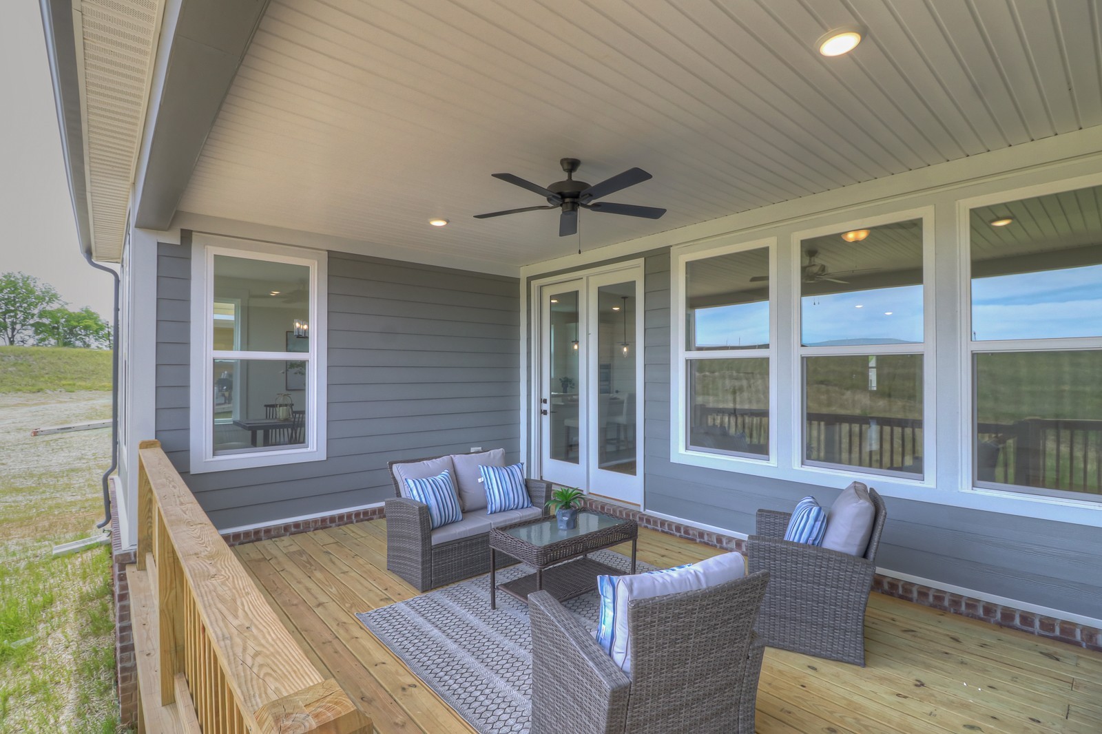 4026 John Marsh Road Spring Hill, TN 37174 - Photo 13 of 31 a view of a patio with couches chairs and potted plants with wooden floor