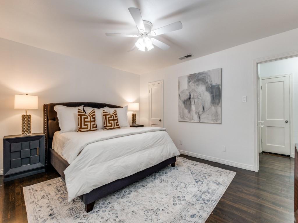 6431 Bordeaux Avenue Dallas, TX 75209 - Photo 12 of 18 a bedroom with a large bed and a chandelier