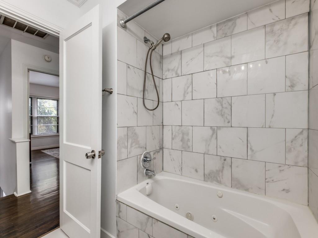 6431 Bordeaux Avenue Dallas, TX 75209 - Photo 15 of 18 a bathroom with a bathtub a sink a window and shower