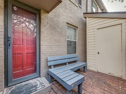 a view of a house with a yard deck and a tree