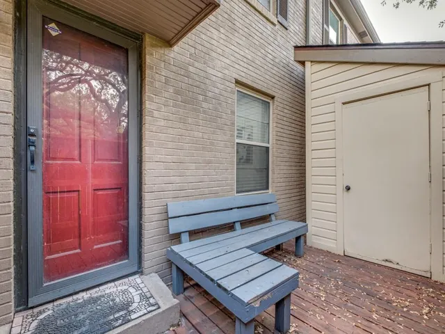 a view of a house with a yard deck and a tree