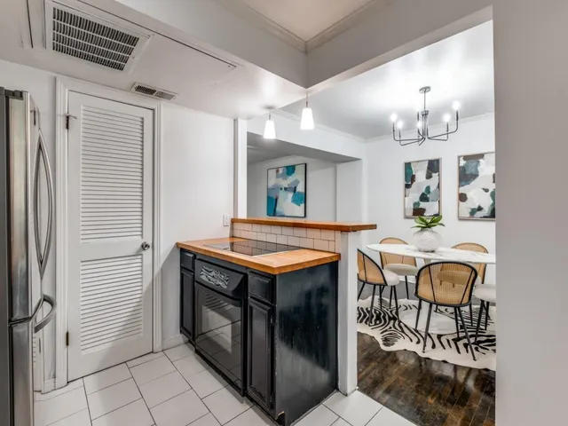 a kitchen with stainless steel appliances granite countertop a stove and a refrigerator