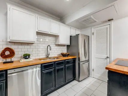 a kitchen with stainless steel appliances a sink cabinets and a counter top space