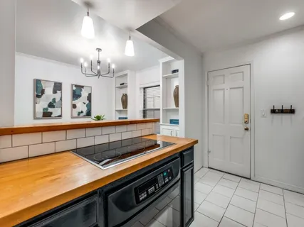 a bedroom with bed and a chandelier