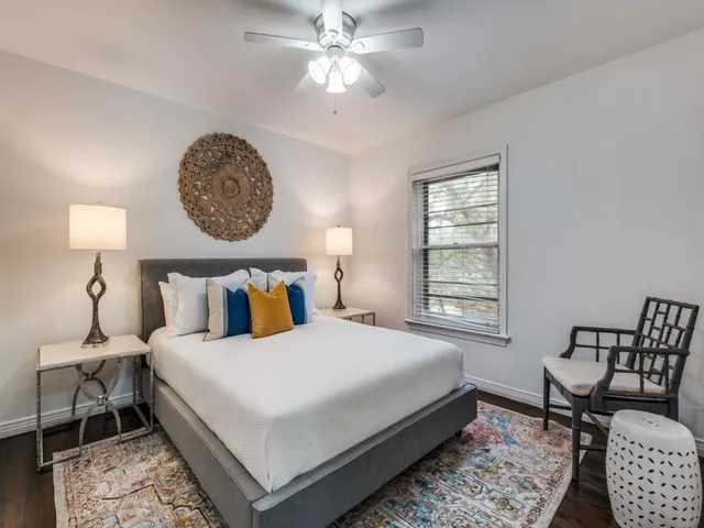 a bedroom with a large bed and a window