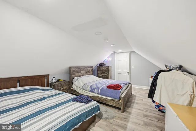 a bedroom with two beds and a lamp