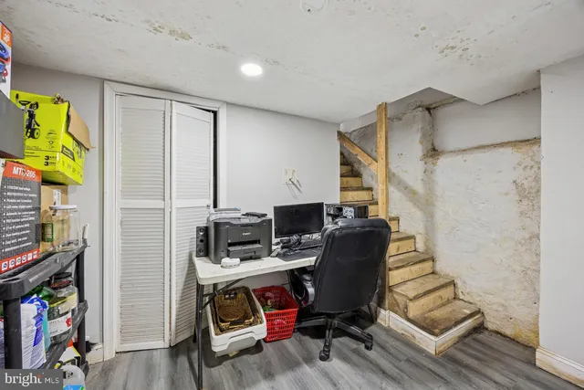 a view of a workspace with furniture and wooden floor