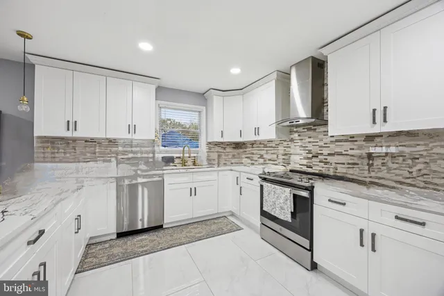 a kitchen with granite countertop white cabinets white stainless steel appliances with a sink and dishwasher