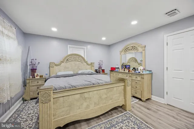 a bed room with a bed and a dresser