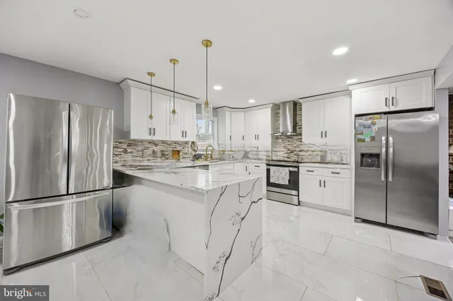 a kitchen with stainless steel appliances granite countertop a refrigerator sink and cabinets