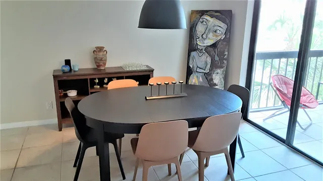 a view of a dining room with furniture and window