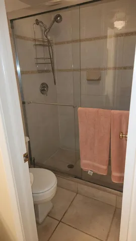 a bathroom with a toilet and shower