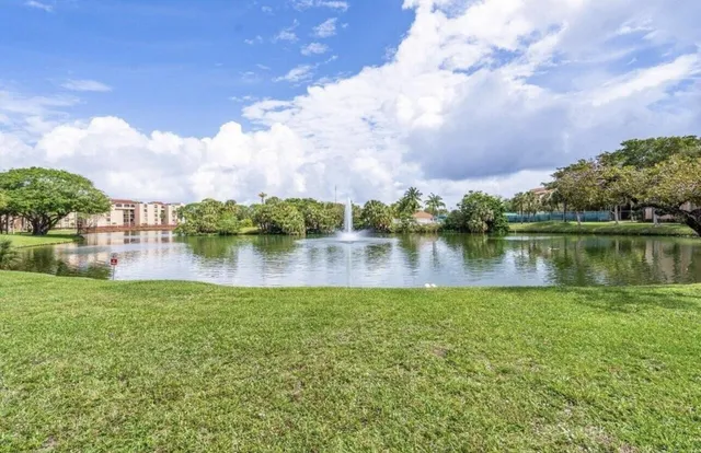 a view of a lake with houses in the background